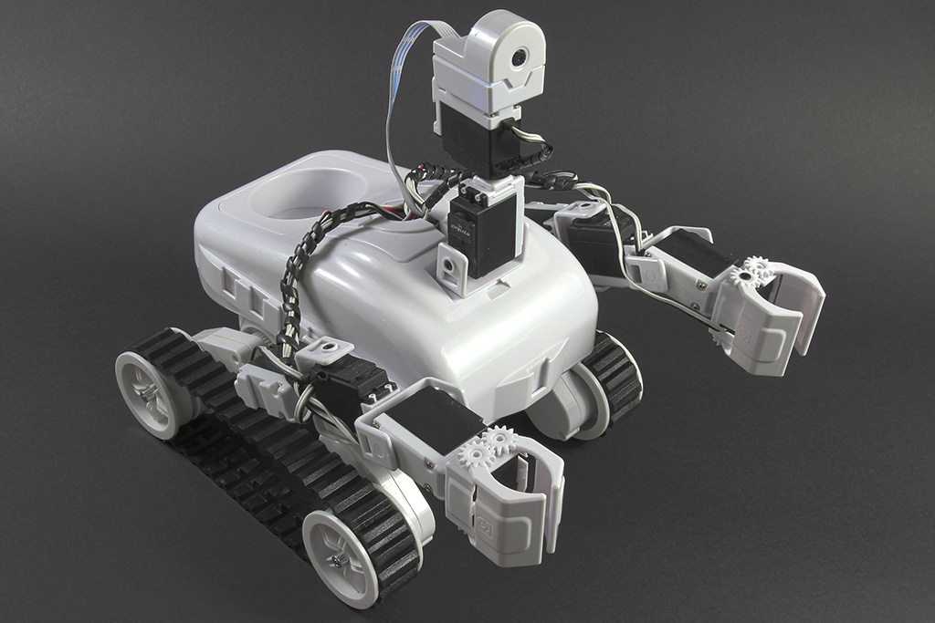 Roli, the white EZ-Robot tracked rover with two gripper arms and a camera on a servo neck